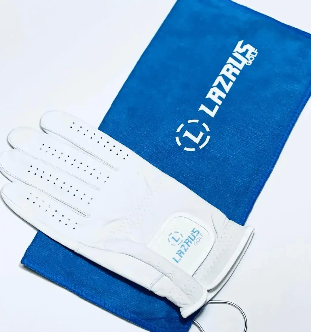 White Lazrus golf glove placed on blue Lazrus Golf branded towel