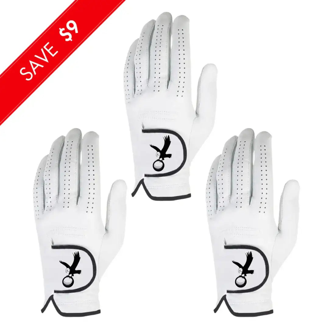Set of three white golf gloves with perforations and black eagle logo holding a golf ball