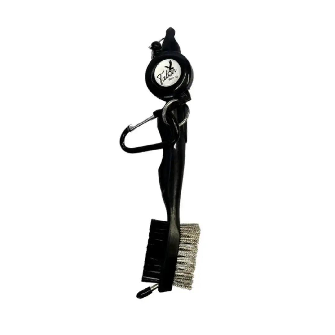 Black golf club cleaning brush with wire bristles, plastic handle, and attached Talon tag