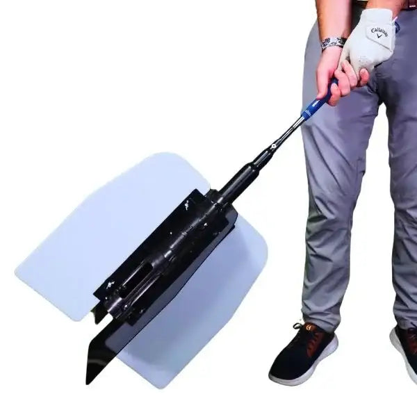 Man holding a golf power swing trainer with large wing attachment for swing practice