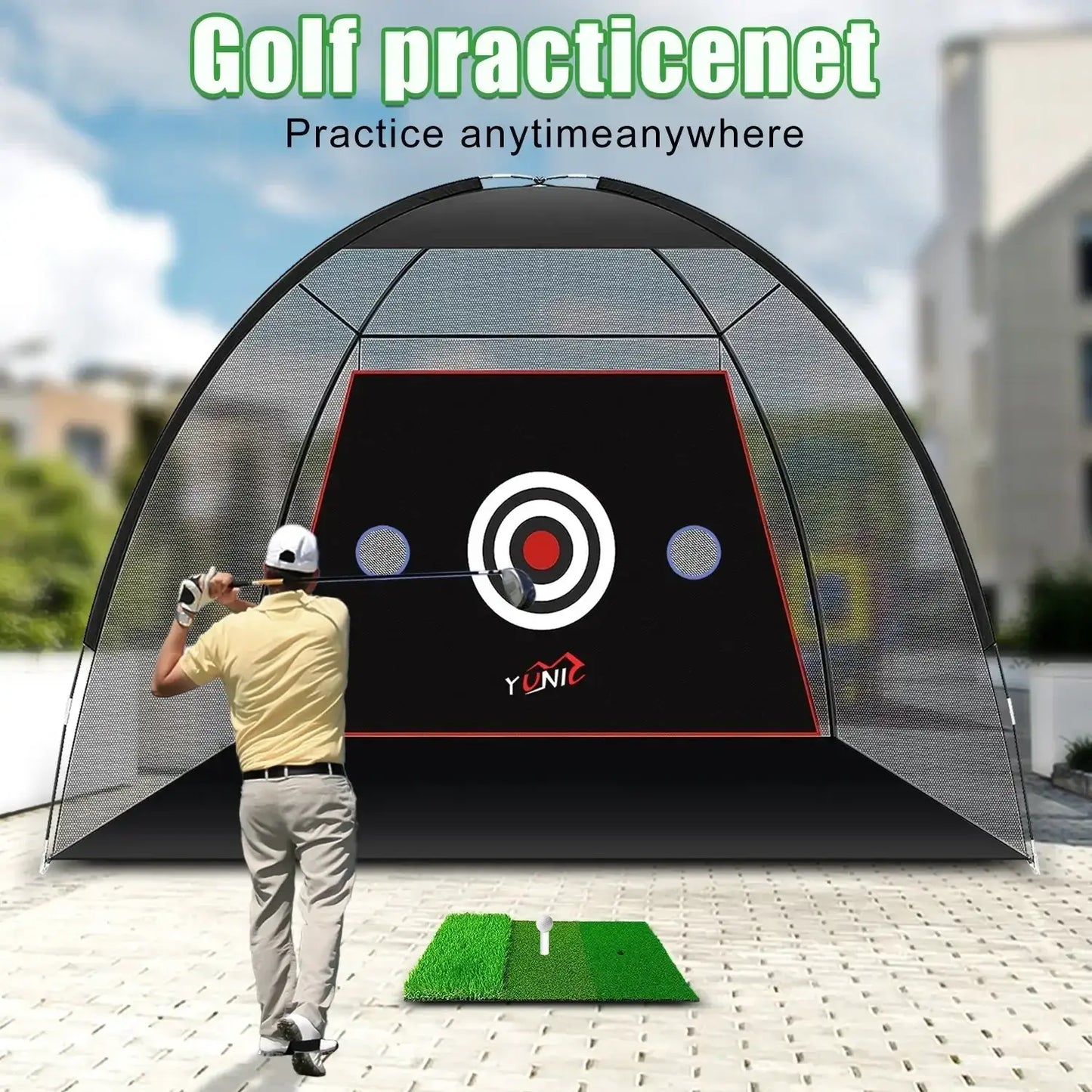 Man practicing golf swing in front of a black golf practice net with target and green hitting mat outdoors