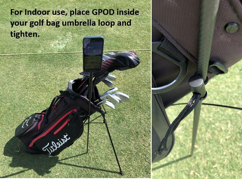 Golf bag with Titleist logo standing on grass, smartphone mounted using GPOD inside umbrella loop, close-up of tightening detail