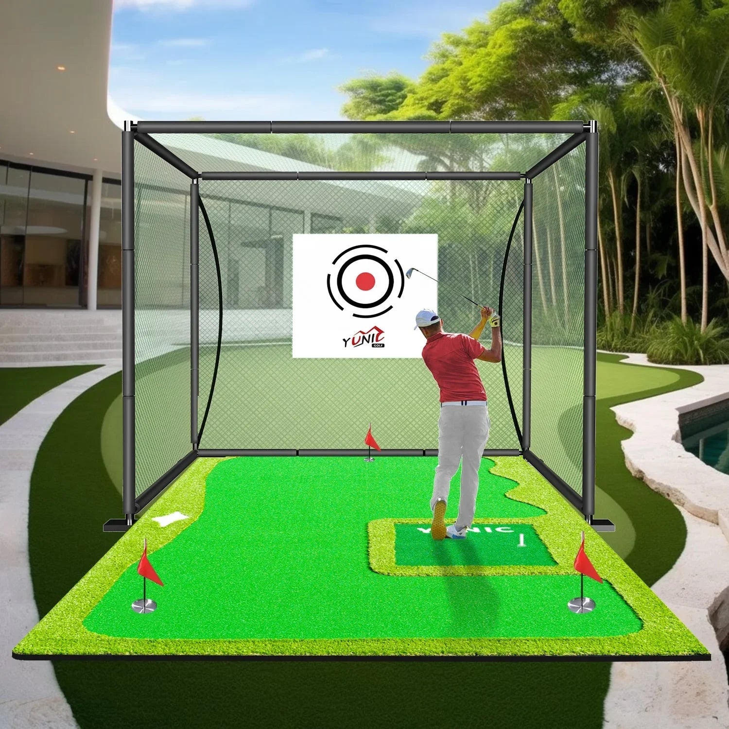 Man practicing golf swing in backyard golf practice net with putting green and target