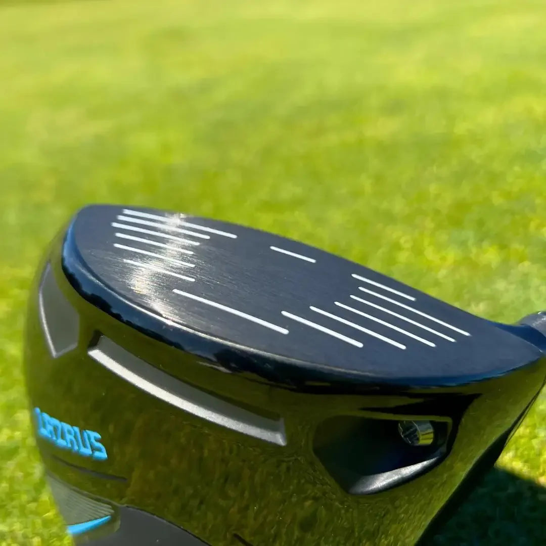 Close-up of Lazrus golf driver club face on green grass golf course