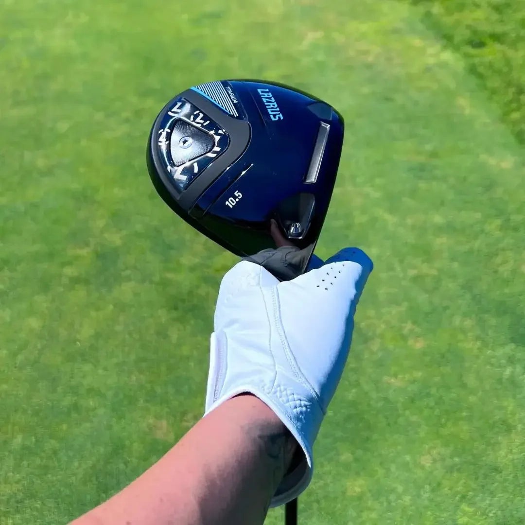 Hand wearing white golf glove holding Lazrus 10.5 titanium driver over green grass