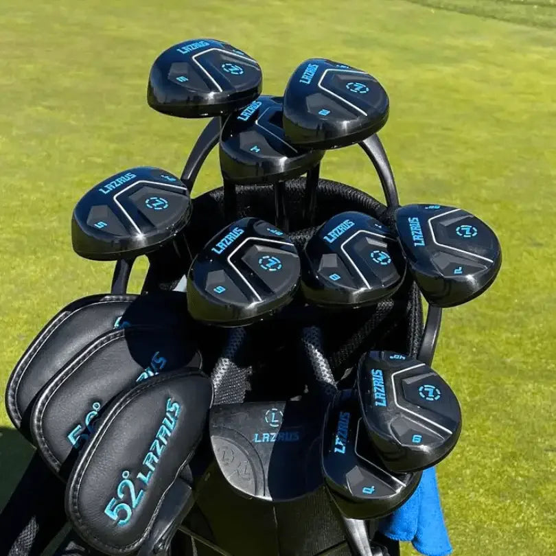 Set of Lazrus black golf hybrid clubs with blue branding in a golf bag on green grass