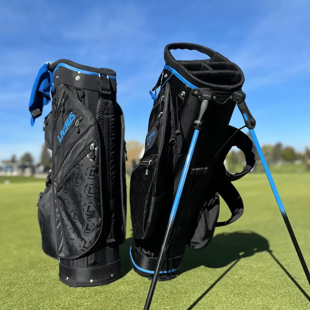 Two black and blue Lazrus golf bags standing on a green golf course under clear blue sky