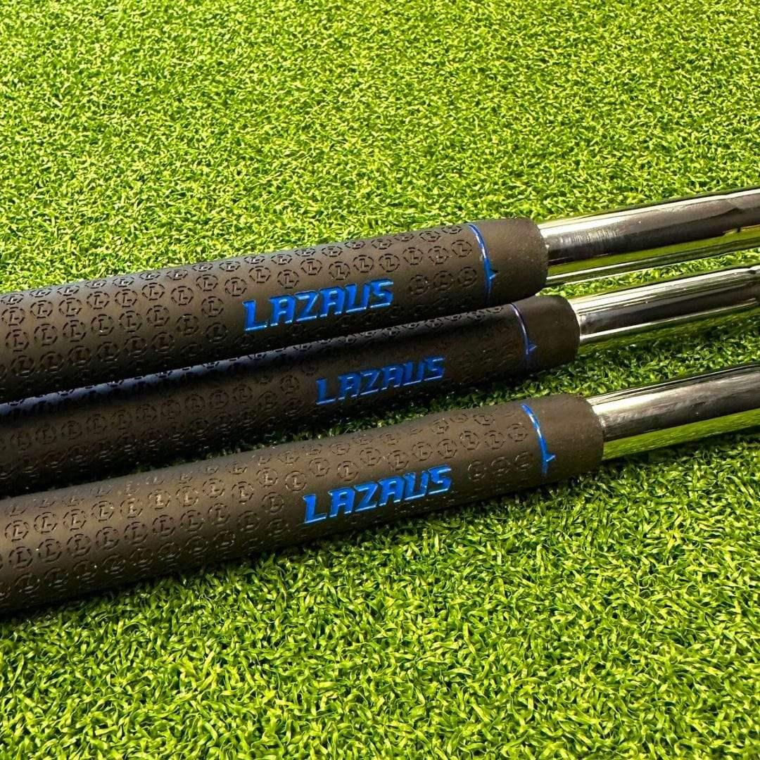 Close-up of three Lazarus golf club grips with blue branding on green artificial turf