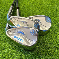 Set of three Lazrus forged cavity back golf wedges on artificial grass