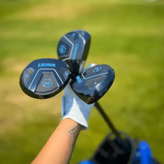 Hand holding Lazrus golf fairway woods clubs with black and blue design on golf course background