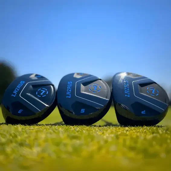Lazrus golf fairway woods set of three clubs with black and blue heads on grass under clear blue sky