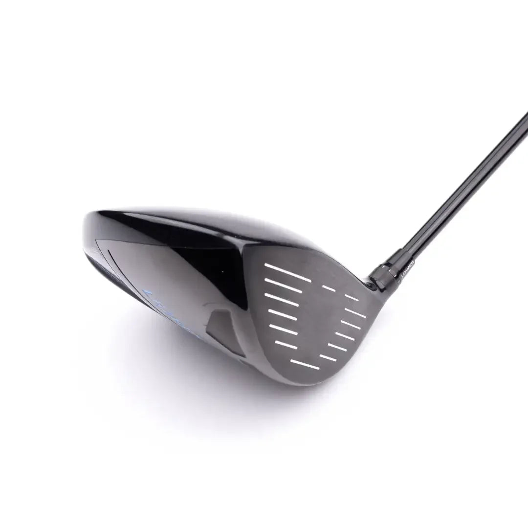 Close-up of black adjustable golf driver club head with reflective surface and alignment markings