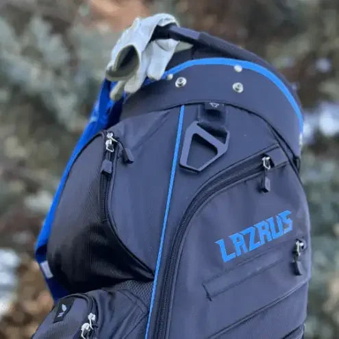 Premium black Lazrus golf bag with blue accents and multiple zippered pockets outdoors