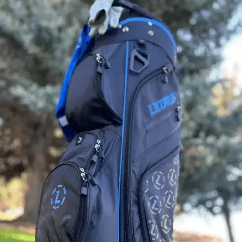 Black Lazrus premium golf bag with blue accents and multiple zippered pockets outdoors