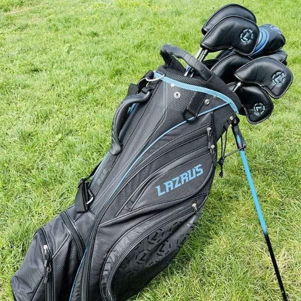 Black Lazrus premium golf bag with clubs on green grass