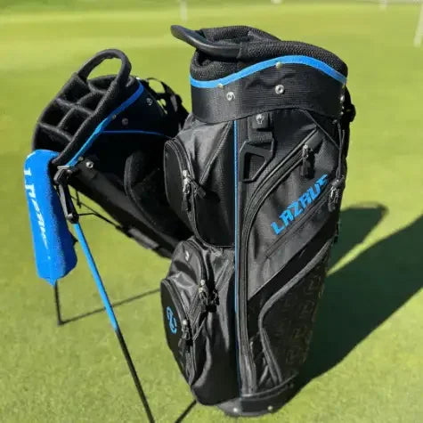 Black and blue Lazrus premium golf bags standing on green golf course grass