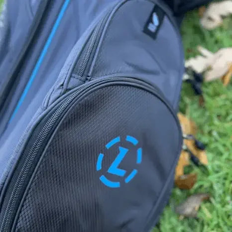 Close-up of Lazrus Premium black golf bag with blue logo on grass background