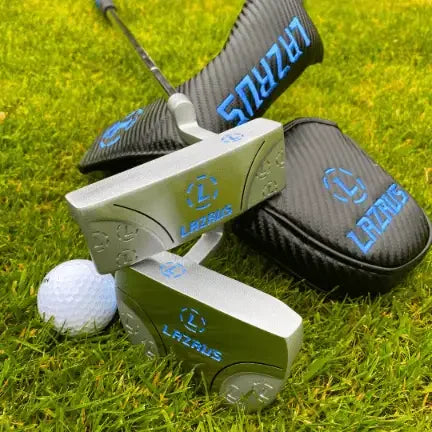 Lazrus premium golf putters with milled face and magnetic black head covers on green grass next to a golf ball