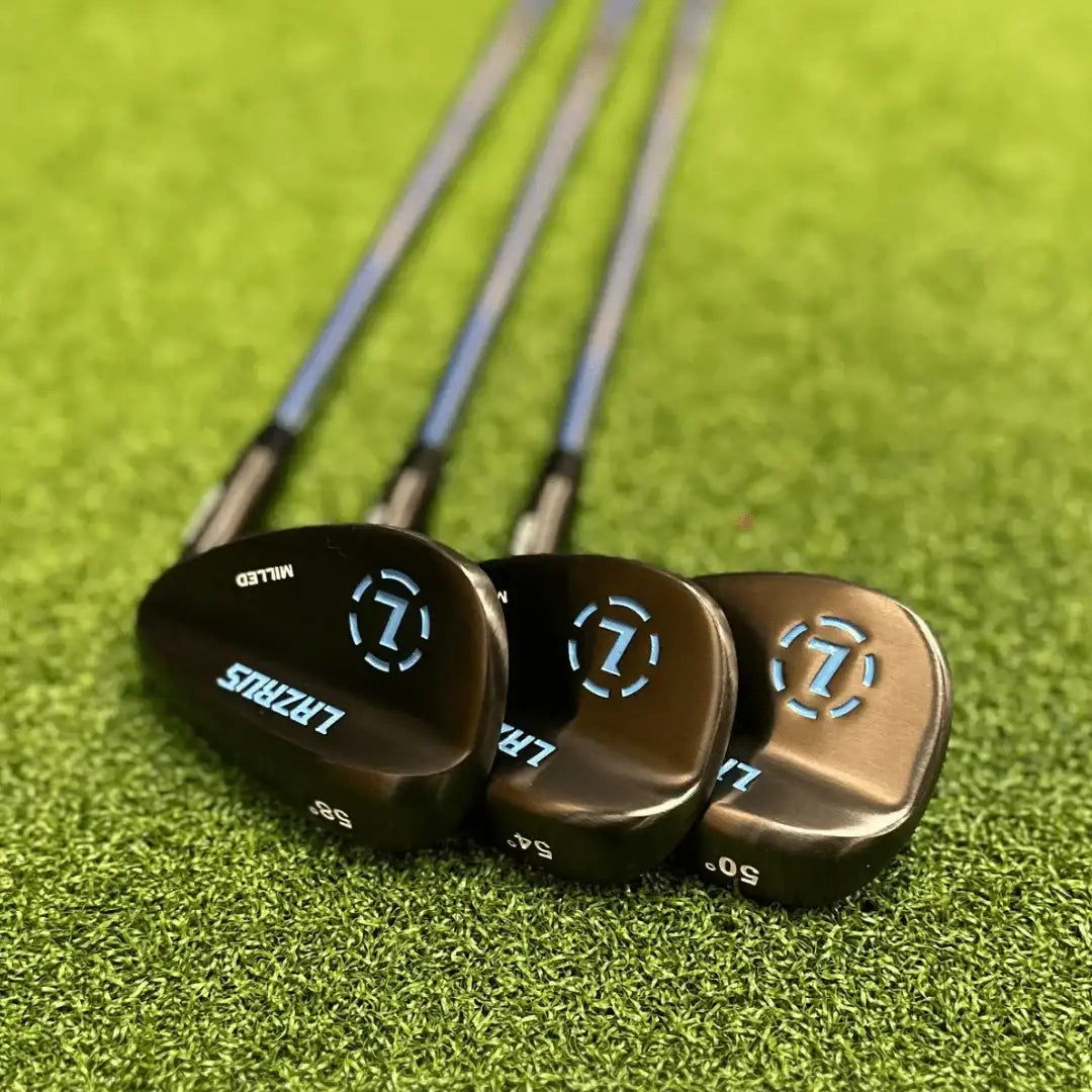 Set of three Lazrus forged golf wedges (50, 54, 58 degrees) on green turf