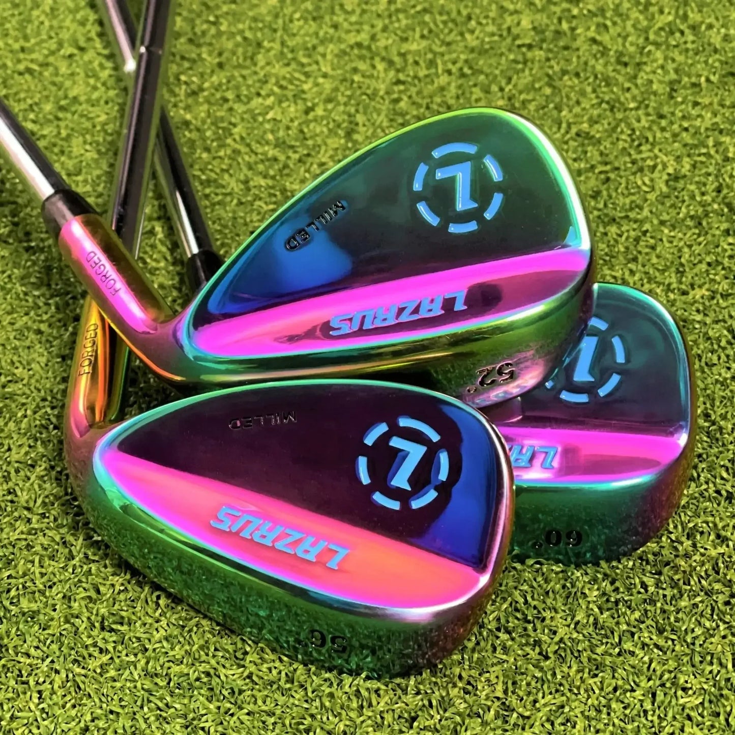 Set of three Lazrus forged golf wedges with vibrant rainbow finish on green turf