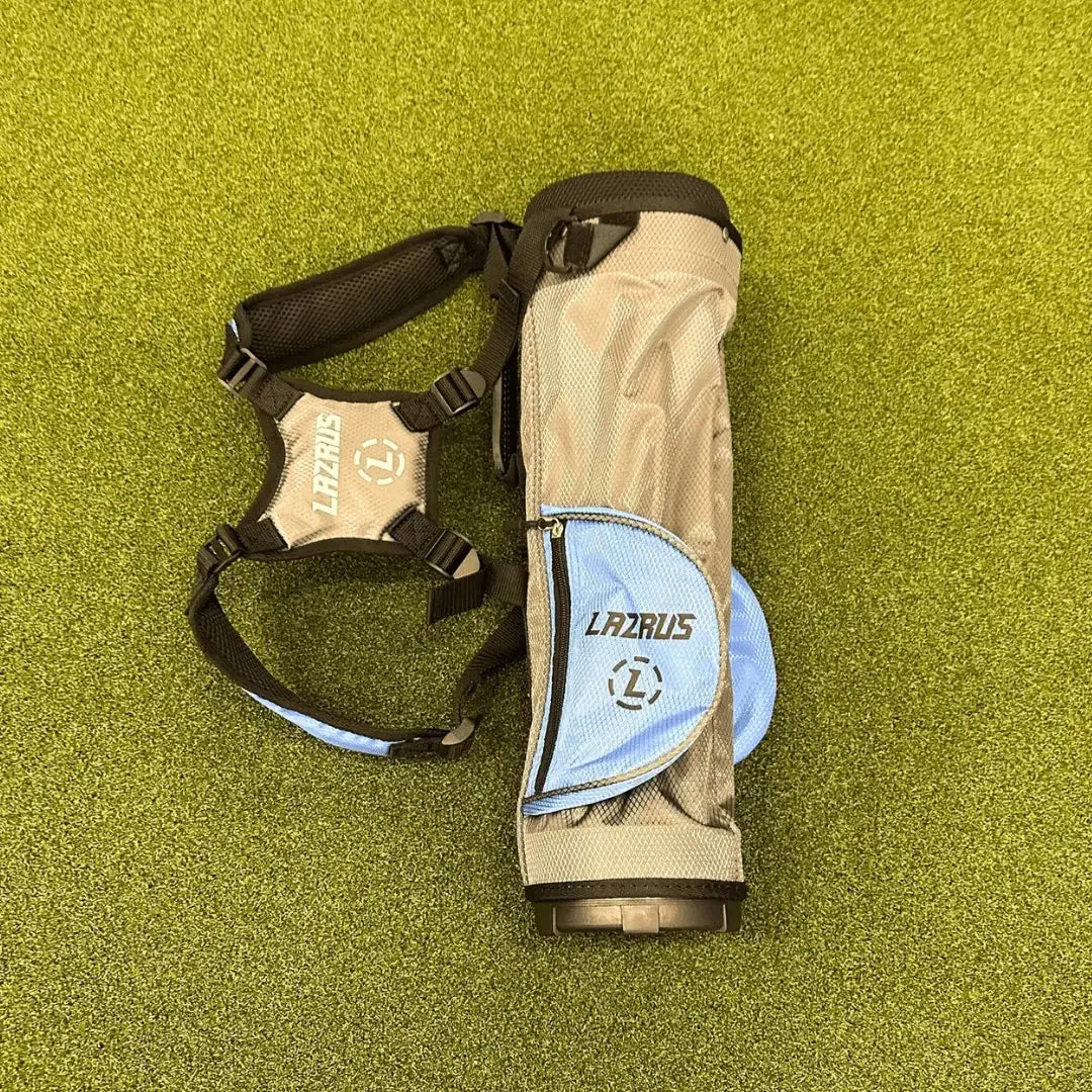 Lazrus golf bag with blue pocket and black straps on green artificial turf