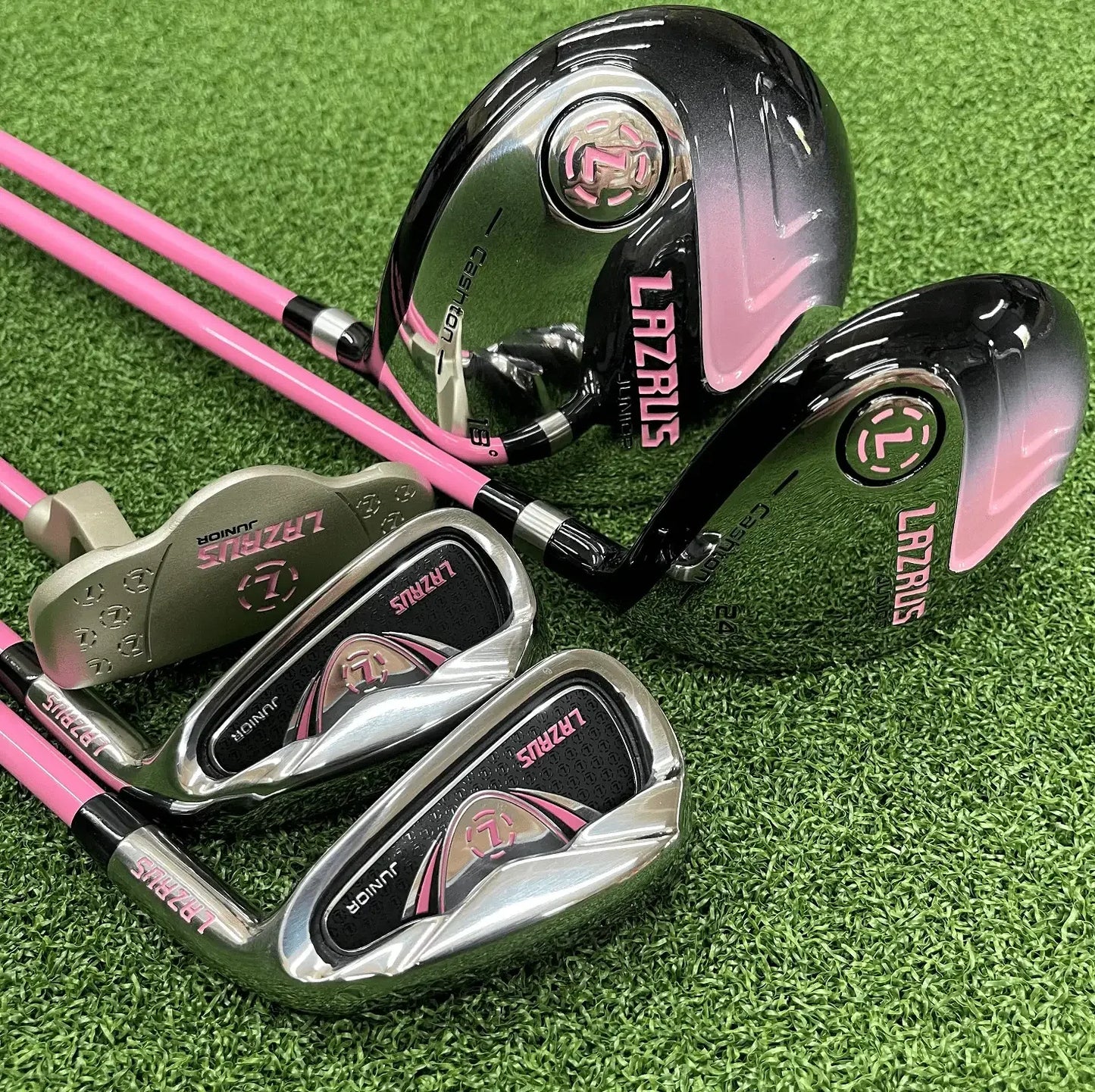 Lazrus Juniors pink and silver golf club set for kids on green turf, right or left hand