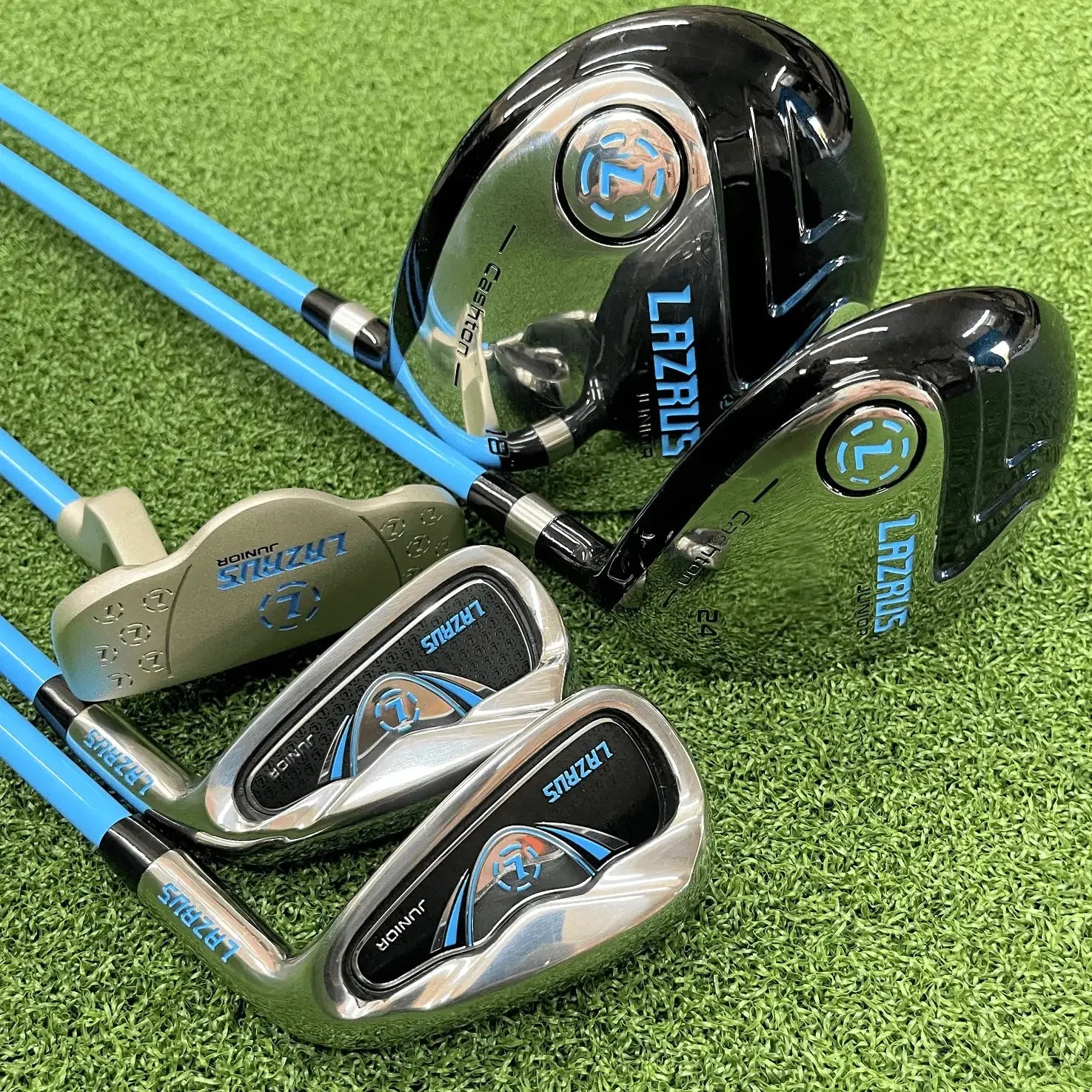 Lazrus junior golf club set with blue shafts on green artificial turf for boys and girls