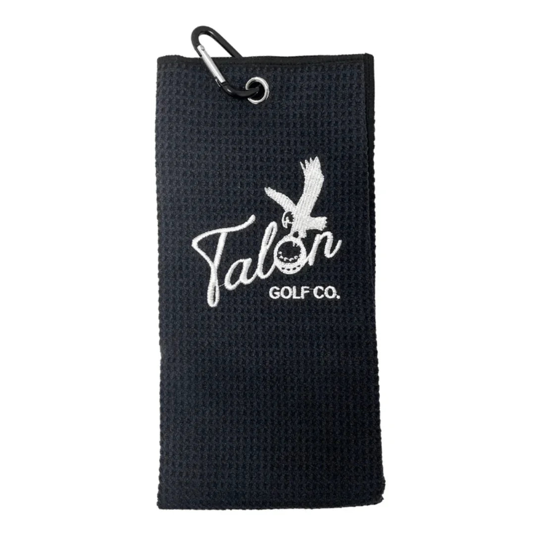 Black waffle-texture golf towel with white Talon Golf Co. logo and attached black carabiner