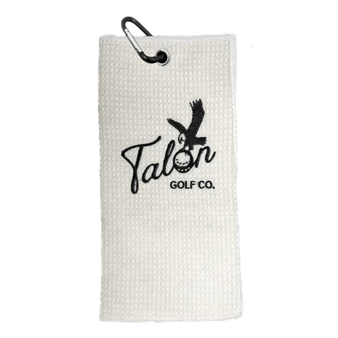 White waffle golf towel with black embroidered Talon Golf Co. logo and attached black carabiner