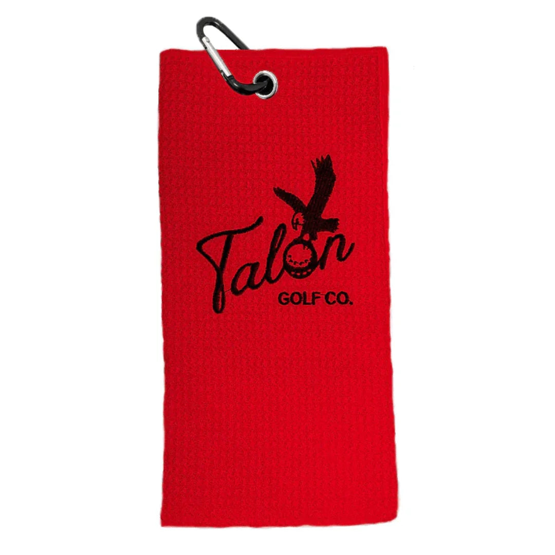 Red waffle golf towel with black Talon Golf Co. logo and attached carabiner clip