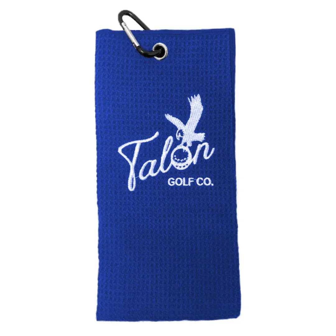 Blue golf towel with white Talon Golf Co. logo and black carabiner clip