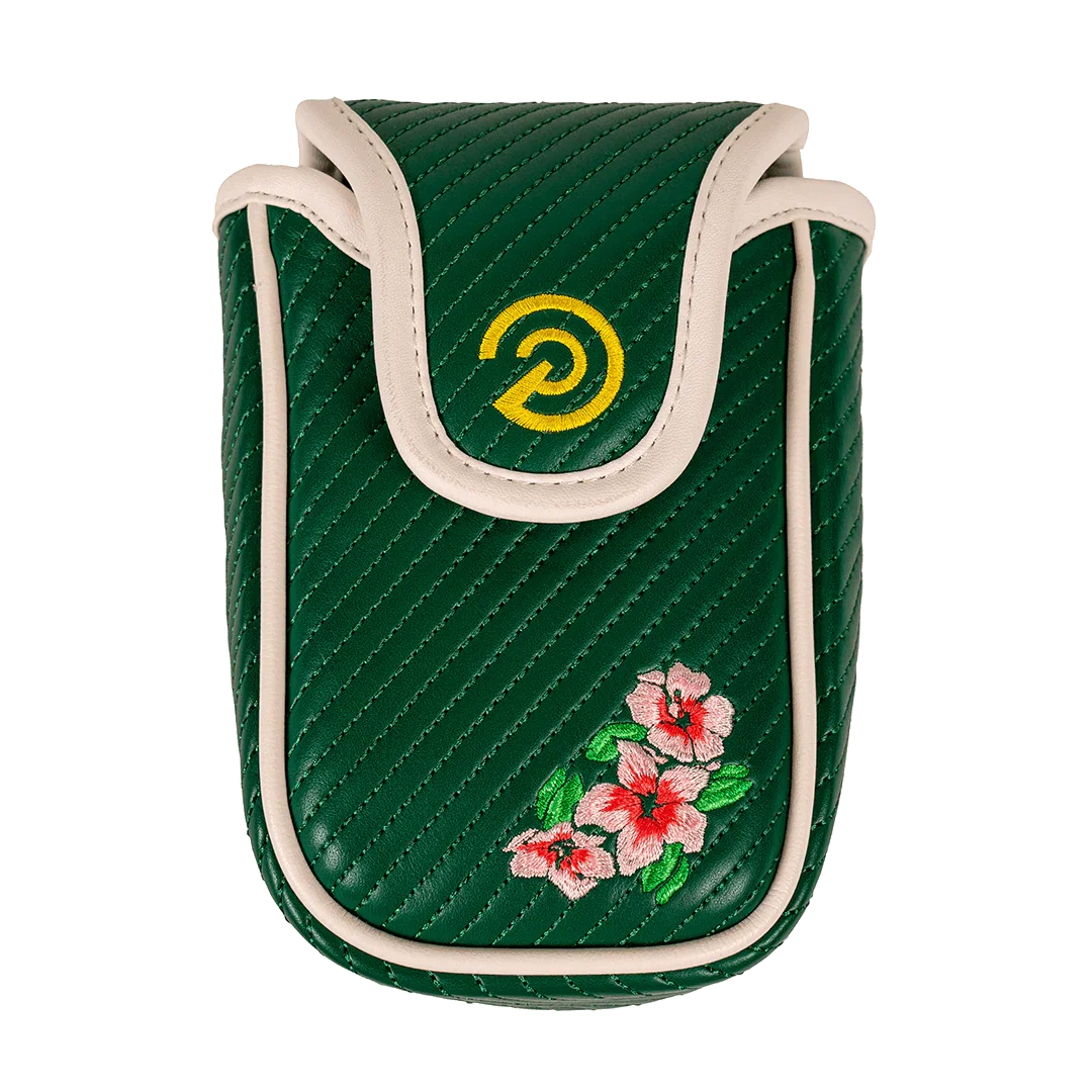 Green quilted soft shell case with white trim, yellow logo, and pink flower embroidery