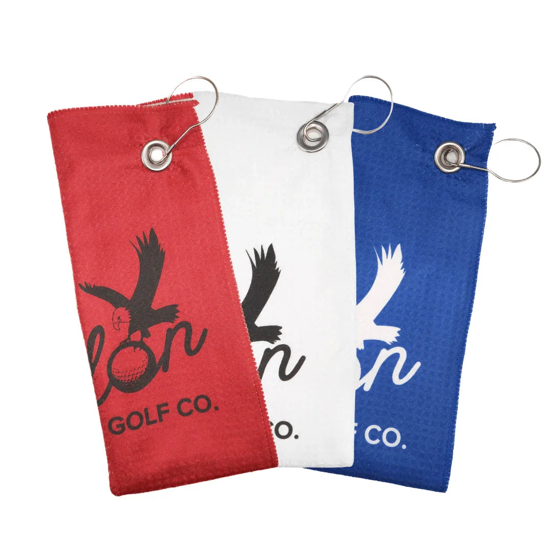 Set of Talon Golf Co. utility golf towels in red, white, and blue with metal grommets and clips