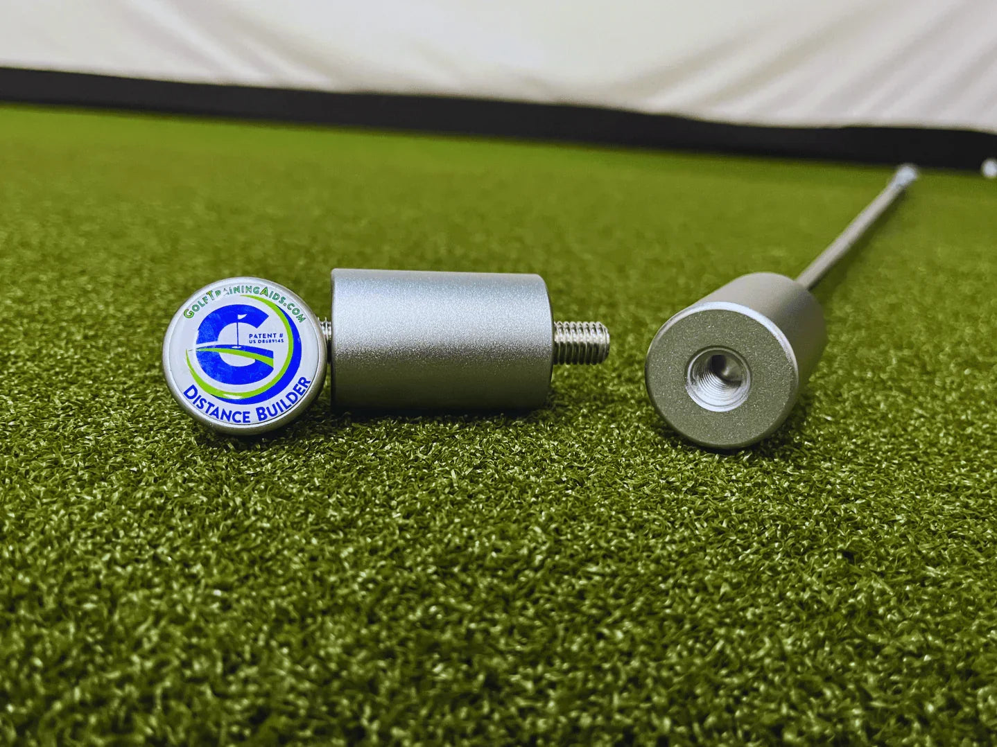 Distance Builder golf training aid on artificial turf for improving golf swing and distance