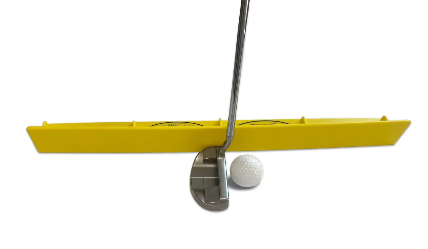 Golf putting training aid with yellow alignment guide, putter, and golf ball on white background