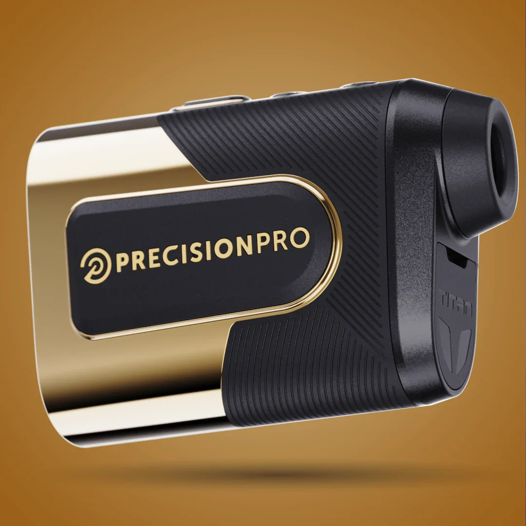 PrecisionPro Titan gold and black slope rangefinder with textured grip on brown background